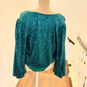 Long sleeve sequence bodysuit. Never worn.
